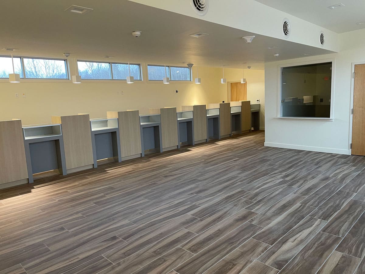 retail building interior with hardwood floor and multiple POS stations