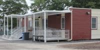 Modular building with a ramp and porch, showcasing the benefits of temporary modular construction for accessibility.