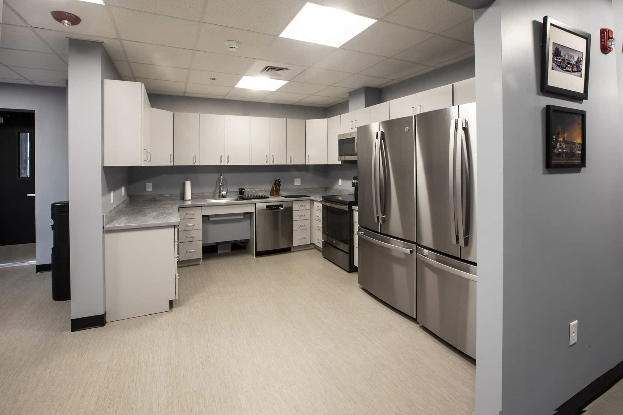 Modern kitchen in a triumph modular building, showcasing sleek stainless steel appliances and modular construction design elements.