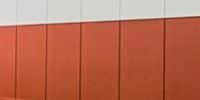 Triumph modular wall panels showcasing a vibrant orange and white design, highlighting features of modular construction.
