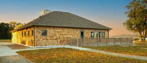Side view of Hingham Community Space and Bath House at sunset.