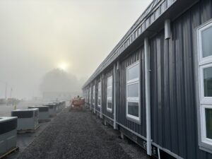 exterior view of the side of the building on a morning when the rooftop HVAC units were being installed