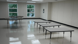 Interior view of a modular building featuring multiple tables, showcasing the flexible design of triumph modular construction for both permanent and temporary uses.